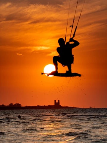 Minnis Bay and sunset over Reculver Towers with jumping kitesurfer 8