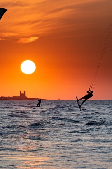 Minnis Bay and the sun setting over Reculver Towers with kitesurfer 6