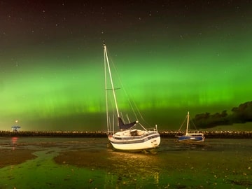 Herne Bay Aurora Yacht with green northern lights