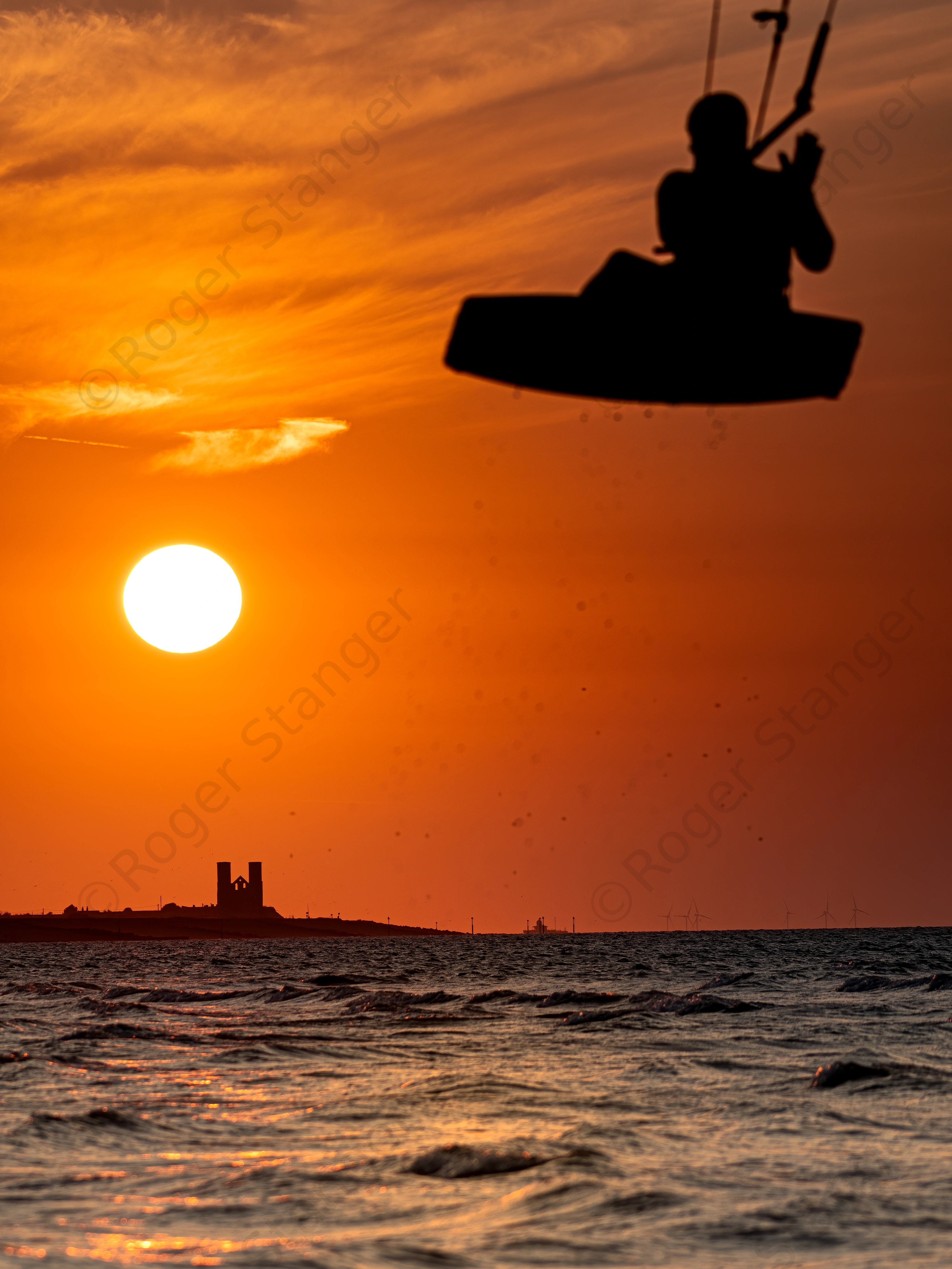 Minnis Bay and sun setting over Reculver Towers with jumping kitesurfer  9